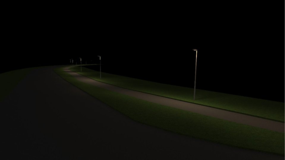 En gång- och cykelväg med gatubelysning syns i mörkret. Ljusstolparna lyser upp vägen i jämna mellanrum och omgivningen är annars helt svart. Foto